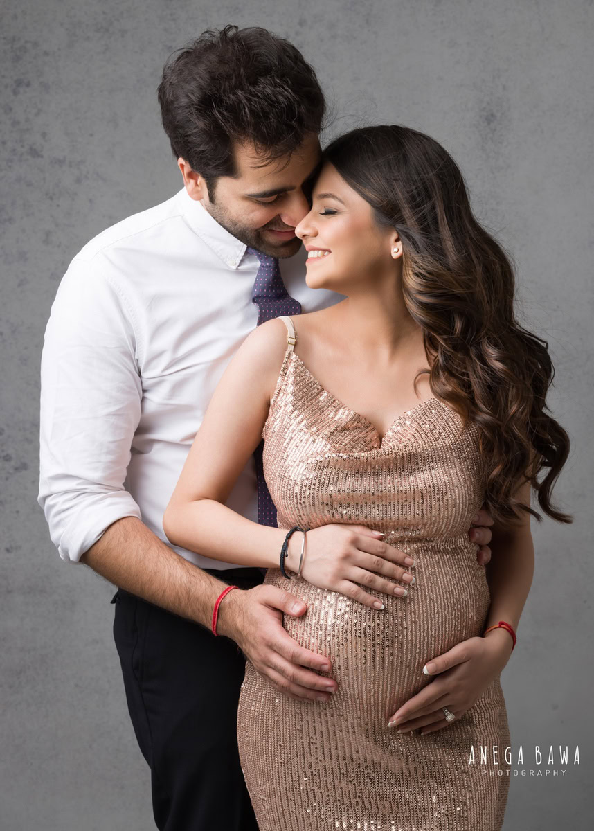 Best Maternity Photoshoot in Delhi: Golden Strap Shimmer Gown with Husband, Grey Backdrop, by Anega Bawa Photography, Gurgaon Noida.