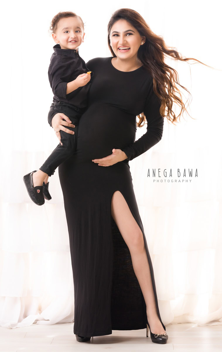 Maternity Photography in Delhi: Black High Slit with Son, White Backdrop, by Anega Bawa Photographer, Gurgaon Noida.