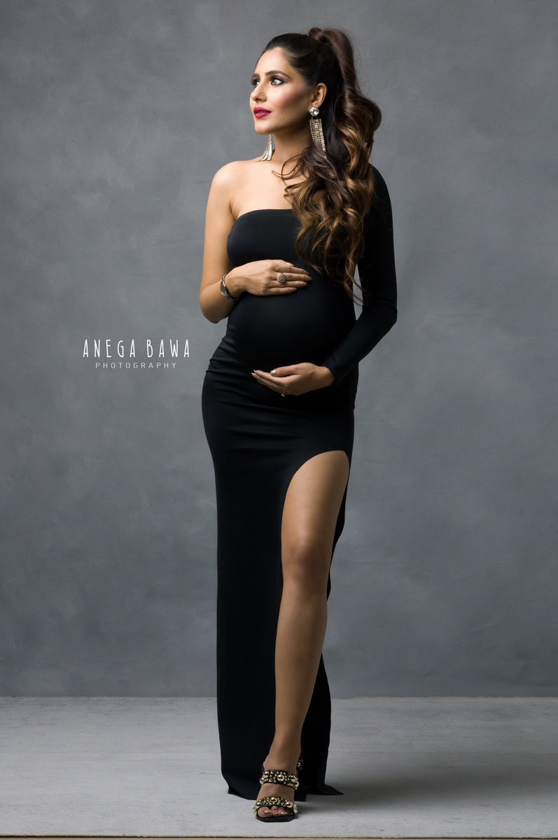 Maternity Photography in Delhi: Black Slit Dress, Grey Backdrop, by Anega Bawa, Photographer Gurgaon Noida.