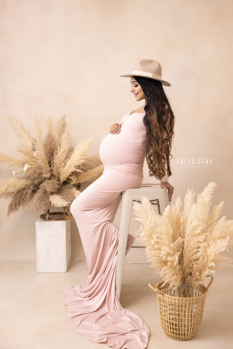 Maternity Photography in Delhi: Nude Pink Dress, Hat, Pampas, Beige Backdrop, by Anega Bawa Photography, Gurgaon Noida.