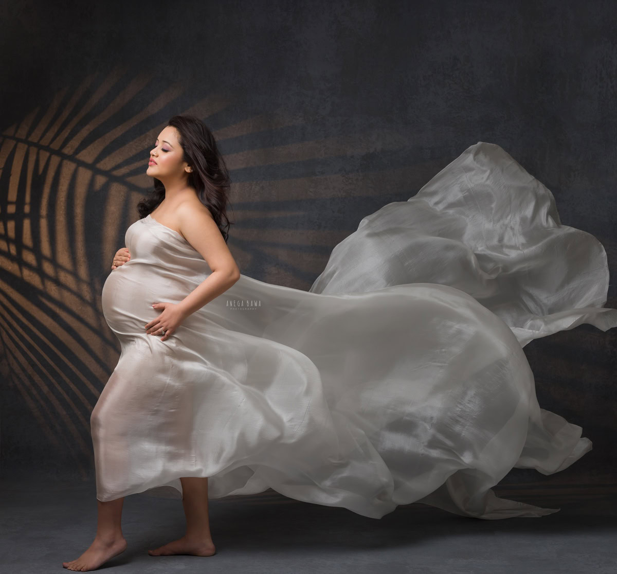 Maternity Photography in Delhi: White Wrap with Leaf Light Play, Grey Backdrop, by Anega Bawa Photographer, Gurgaon Noida.