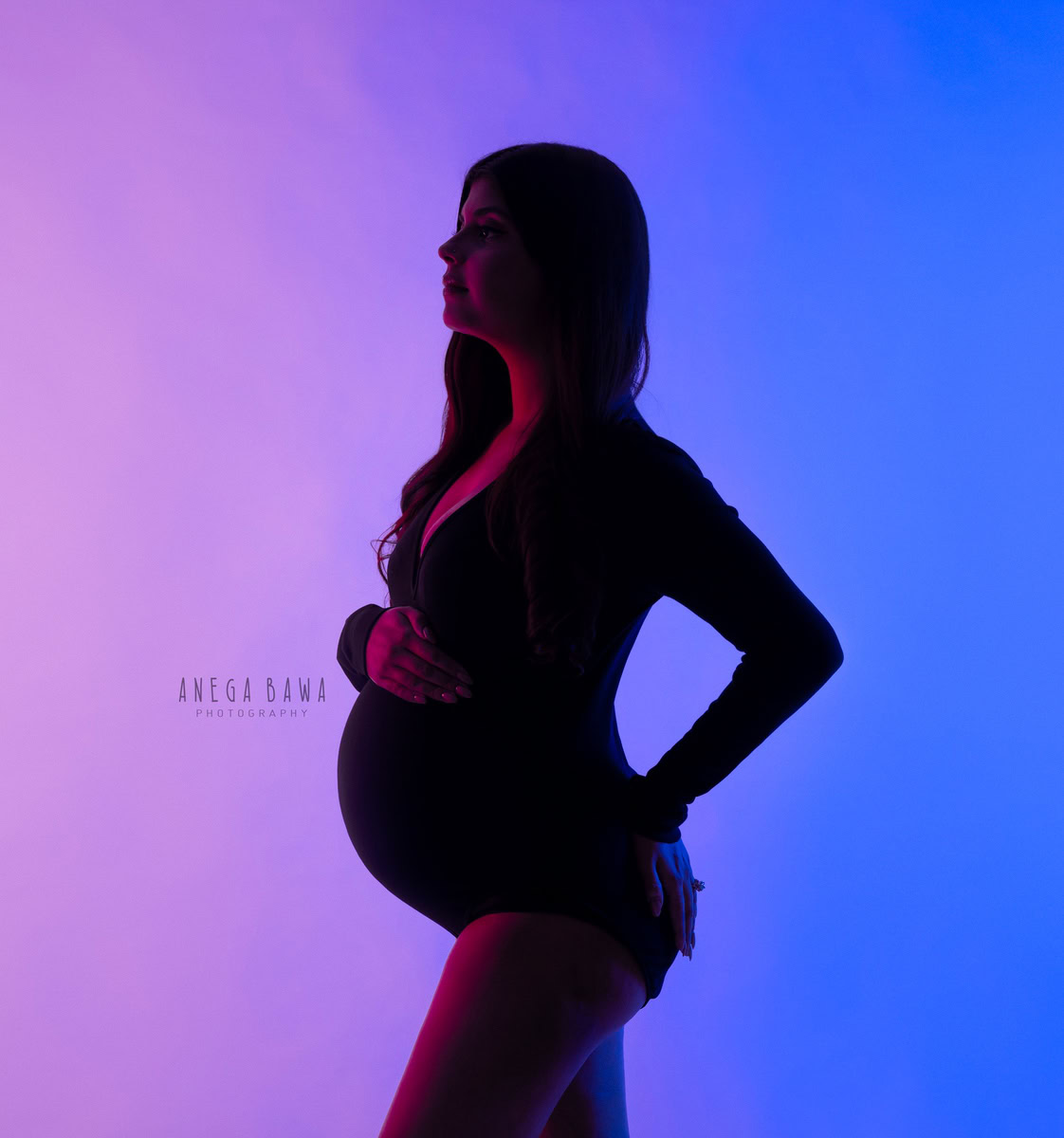 Maternity Shoot in Delhi: Woman in Black Bodysuit, Pink and Blue Backdrop, Anega Bawa, Gurgaon.