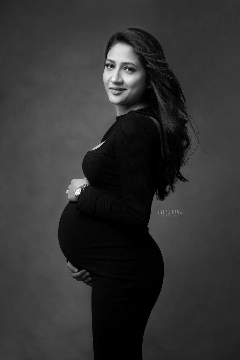 Pregnancy Photography in Delhi: Elegant Black Dress, Dark Grey Backdrop, by Anega Bawa, Photographer Gurgaon Noida.