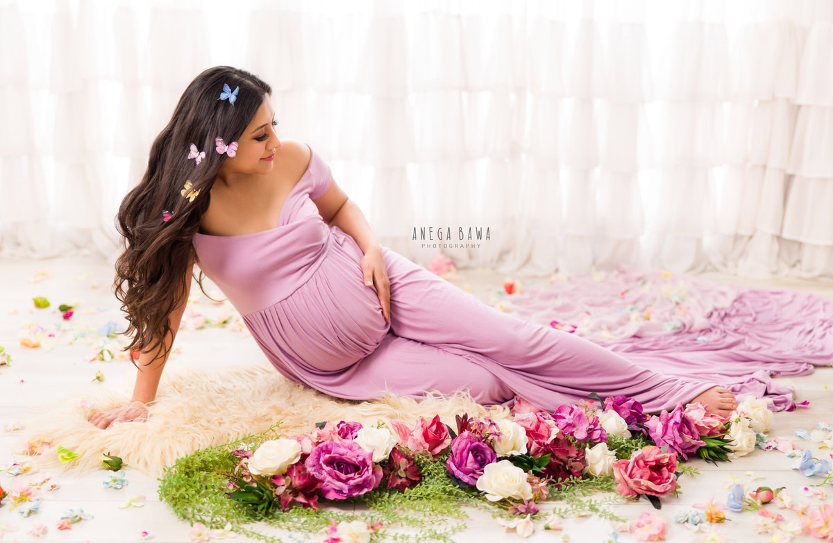 Pregnancy Photography Delhi: Lavender Dress, Flowers on Floor, Beige Rug, by Anega Bawa Photographer, Gurgaon Noida