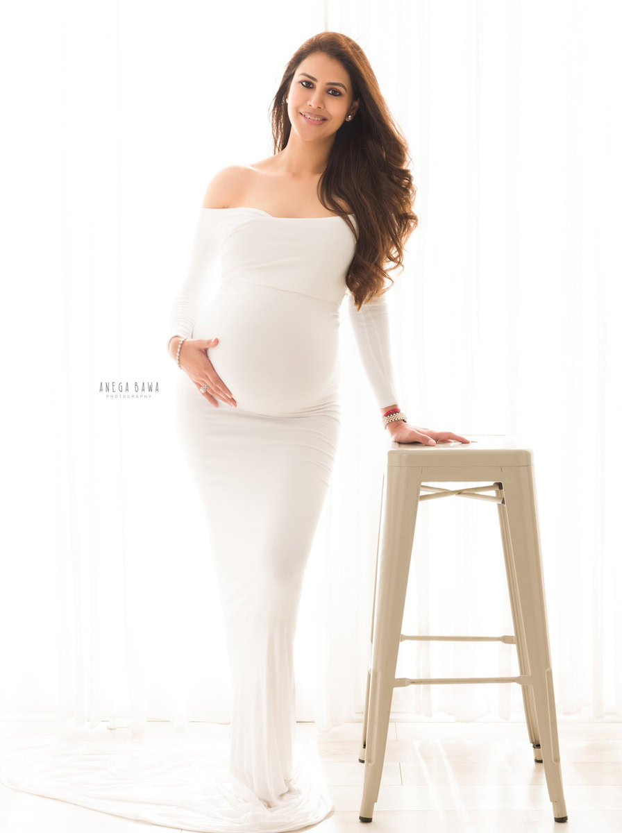 Pregnancy Photography in Delhi: White Dress with Stool, White Backdrop, by Anega Bawa, Photographer Gurgaon Noida.