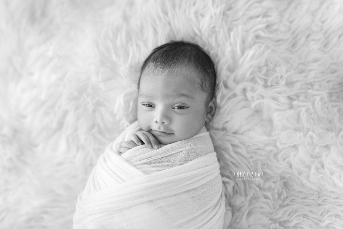 Newborn Photography in Delhi: White Wrap on White Backdrop. Photographer: Anega Bawa Photography, Gurgaon Noida.