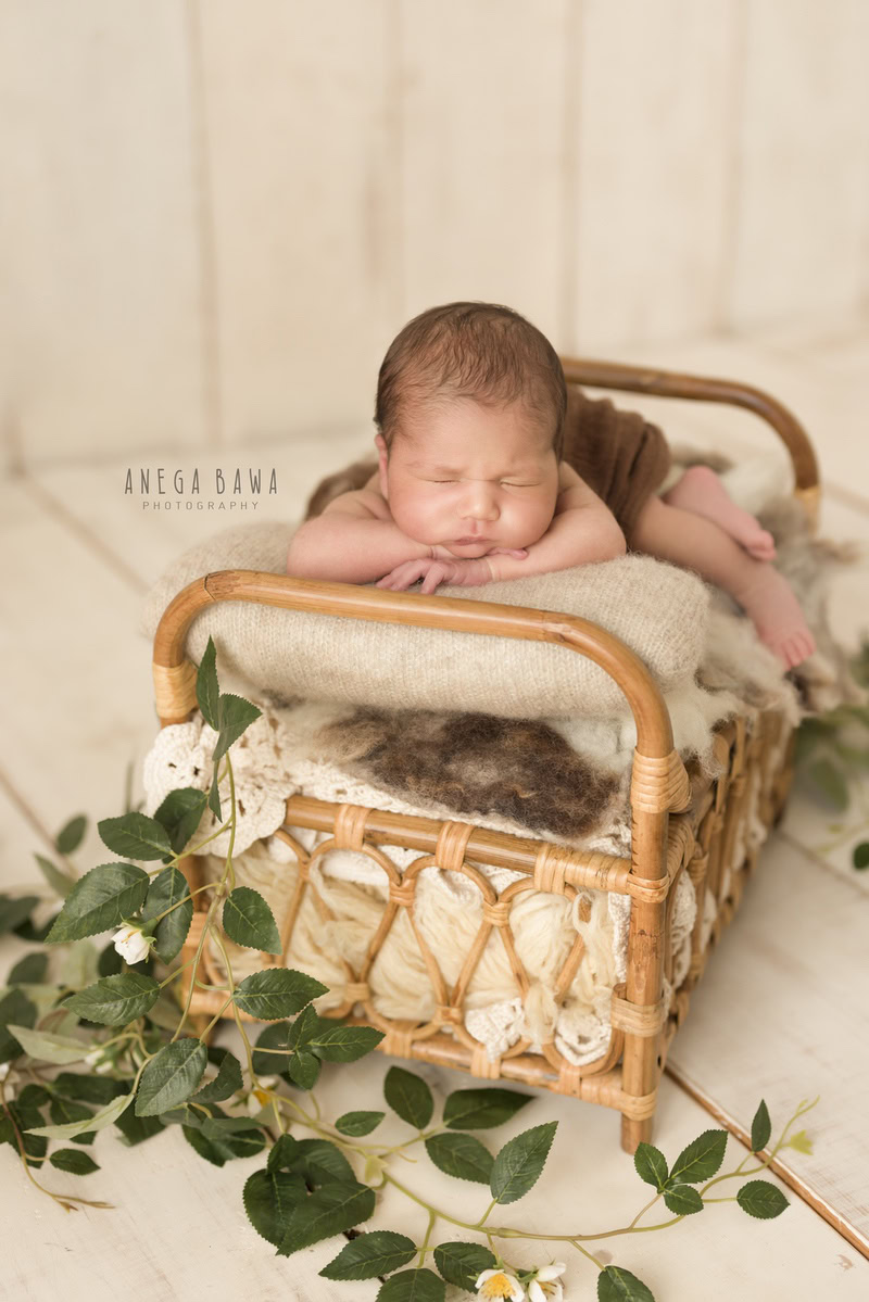 Newborn Photographer in Delhi: Wooden Cot, Sleeping Pose, Beige Backdrop, by Anega Bawa Photography, Gurgaon Noida.