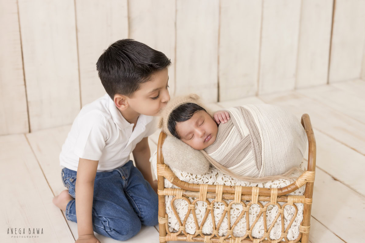 Newborn Photography in Delhi: Beige and White Wrap, Wooden Cot, Sibling, Beige Backdrop, by Anega Bawa Photographer, Gurgaon Noida.