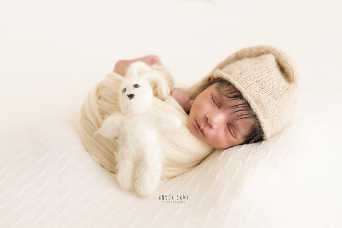 Newborn Photography in Delhi: Beige Wrap, Beige Cap, Soft Toy, White Backdrop, by Anega Bawa Photographer, Gurgaon Noida.