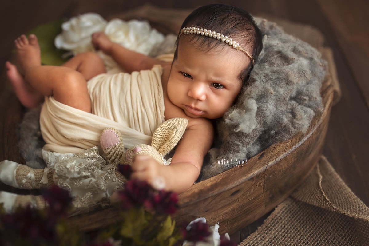 Newborn Photography in Delhi: Beige Wrap, Brown Basket, Pearl Headstring, by Anega Bawa Photographer, Gurgaon Noida.