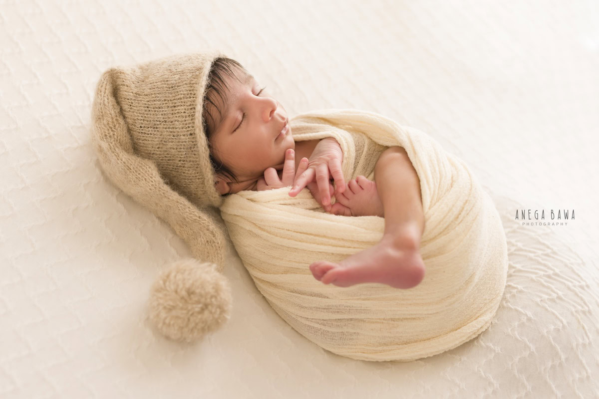 Newborn Photography in Delhi: Beige Wrap, Brown Cap, White Backdrop. Photographer: Anega Bawa Photoshoot, Gurgaon Noida. Newborn Photography in Delhi: Beige Wrap, Brown Cap, White Backdrop. Photographer: Anega Bawa Photoshoot, Gurgaon Noida. Newborn Photography in Delhi: Beige Wrap, Brown Cap, White Backdrop. Photographer: Anega Bawa Photoshoot, Gurgaon Noida.