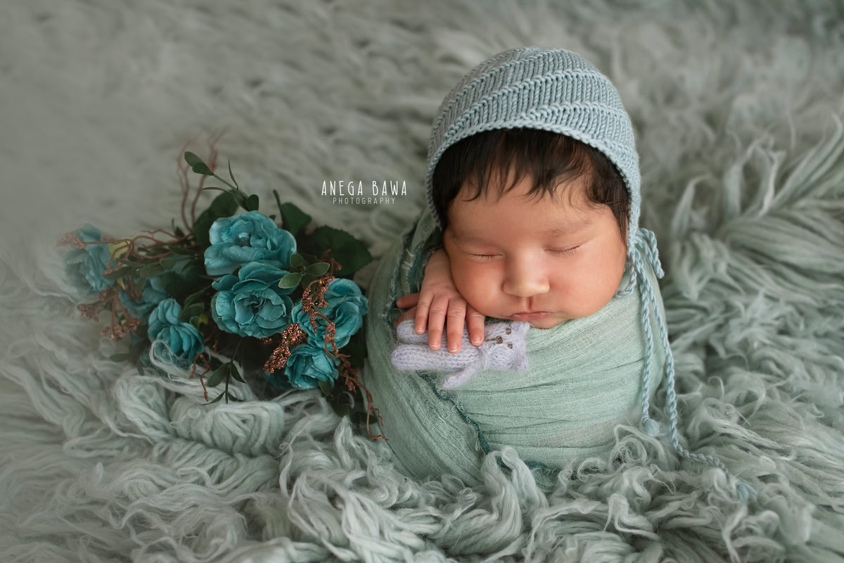 Newborn Photography in Delhi: Blue Wrap with Blue Cap, Grey Rug, Blue Flowers, by Anega Bawa Photographer, Gurgaon Noida.