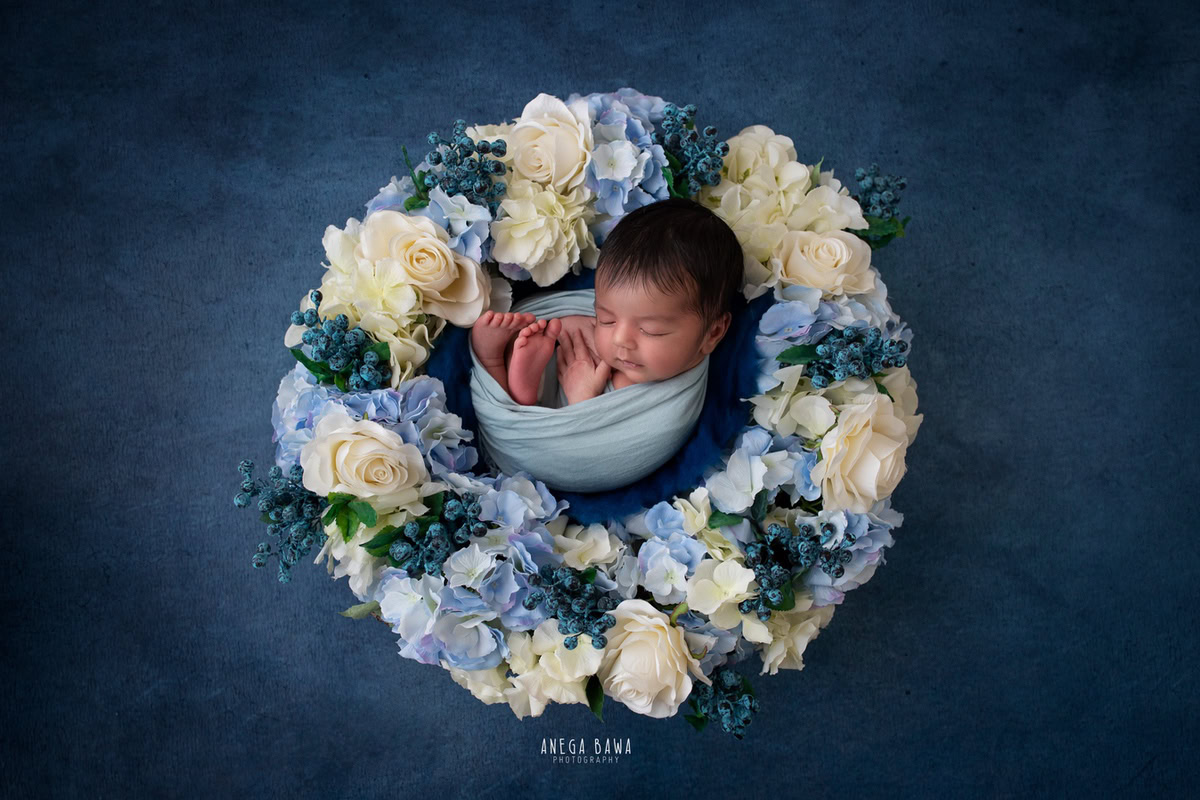 Newborn Photography in Delhi: Blue Wrap, Blue and White Floral Basket, Blue Backdrop, by Anega Bawa Photographer, Gurgaon Noida.