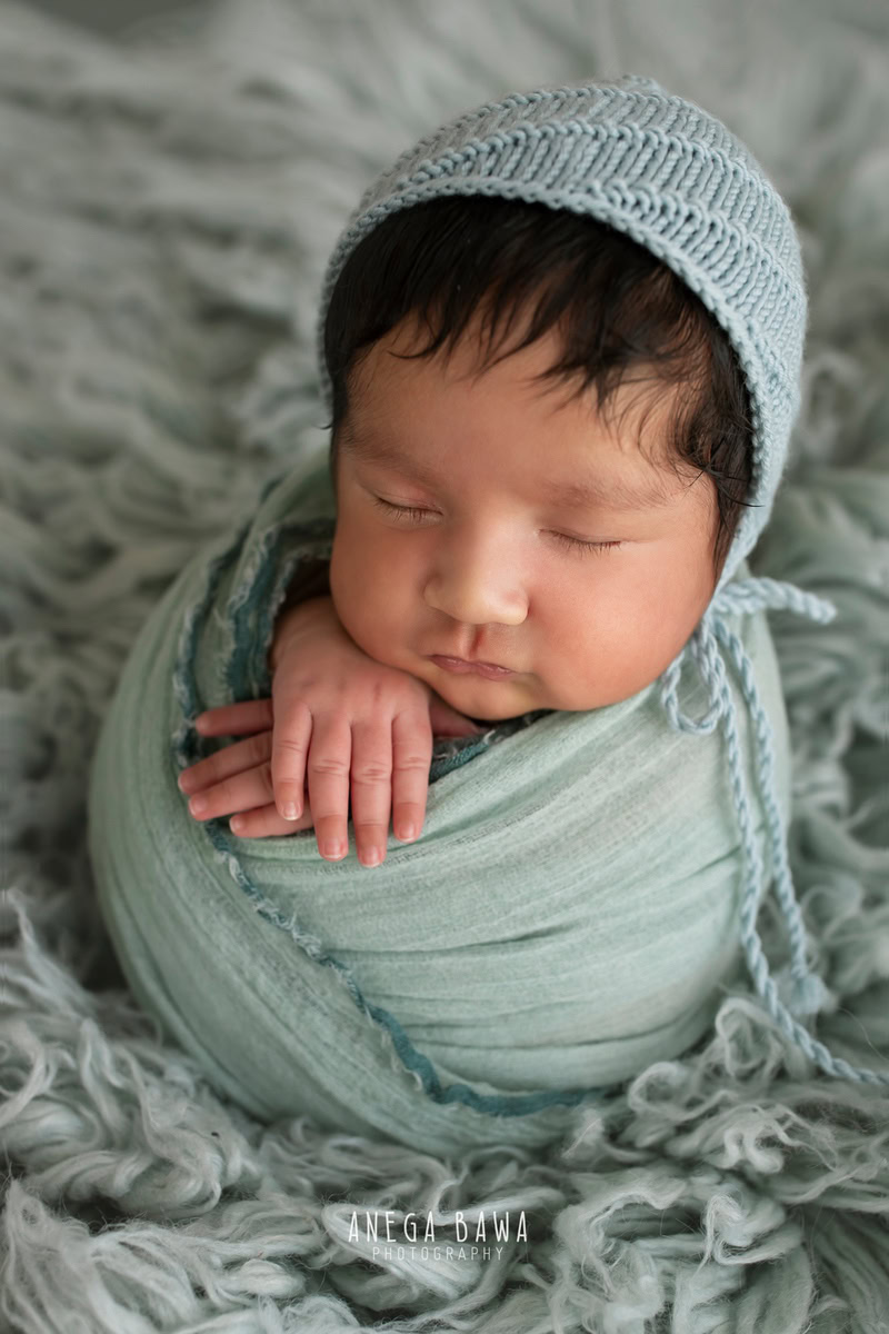 Newborn Photography in Delhi: Blue Wrap, Grey Rug, Blue Cap. Photographer: Anega Bawa, Gurgaon Noida.