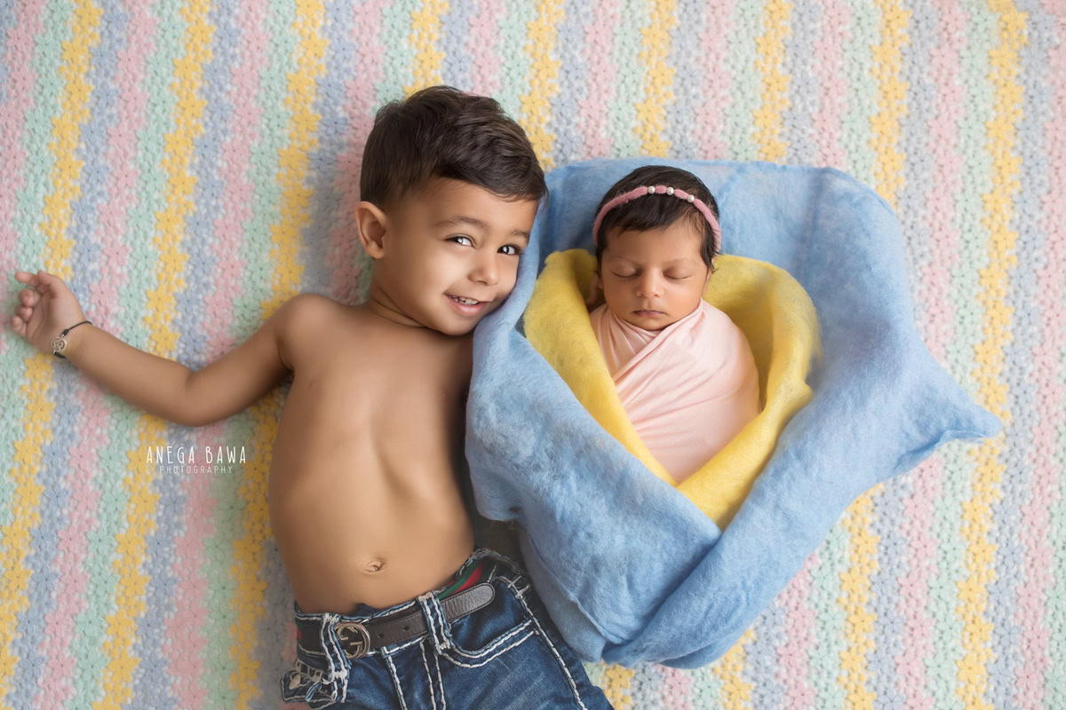 Newborn Photography in Delhi: Blue and Yellow Sheet, Sibling in Pink Wrap, White Backdrop, by Anega Bawa Photographer, Gurgaon Noida.
