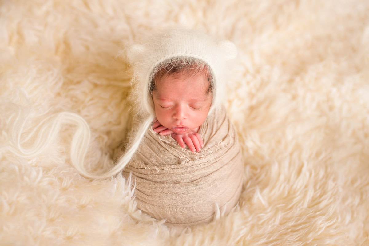 Newborn Photography in Delhi: Brown Wrap, Beige Rug, Beige Backdrop, by Anega Bawa Photographer, Gurgaon Noida.