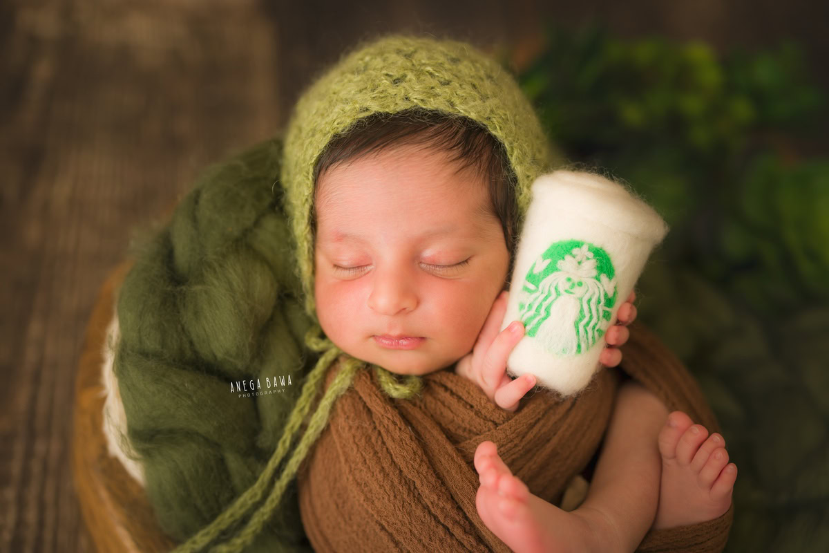 Newborn Photography in Delhi: Brown Wrap, Cute Starbucks Glass, Brown Backdrop. Photographer: Anega Bawa Photoshoot, Gurgaon Noida.
