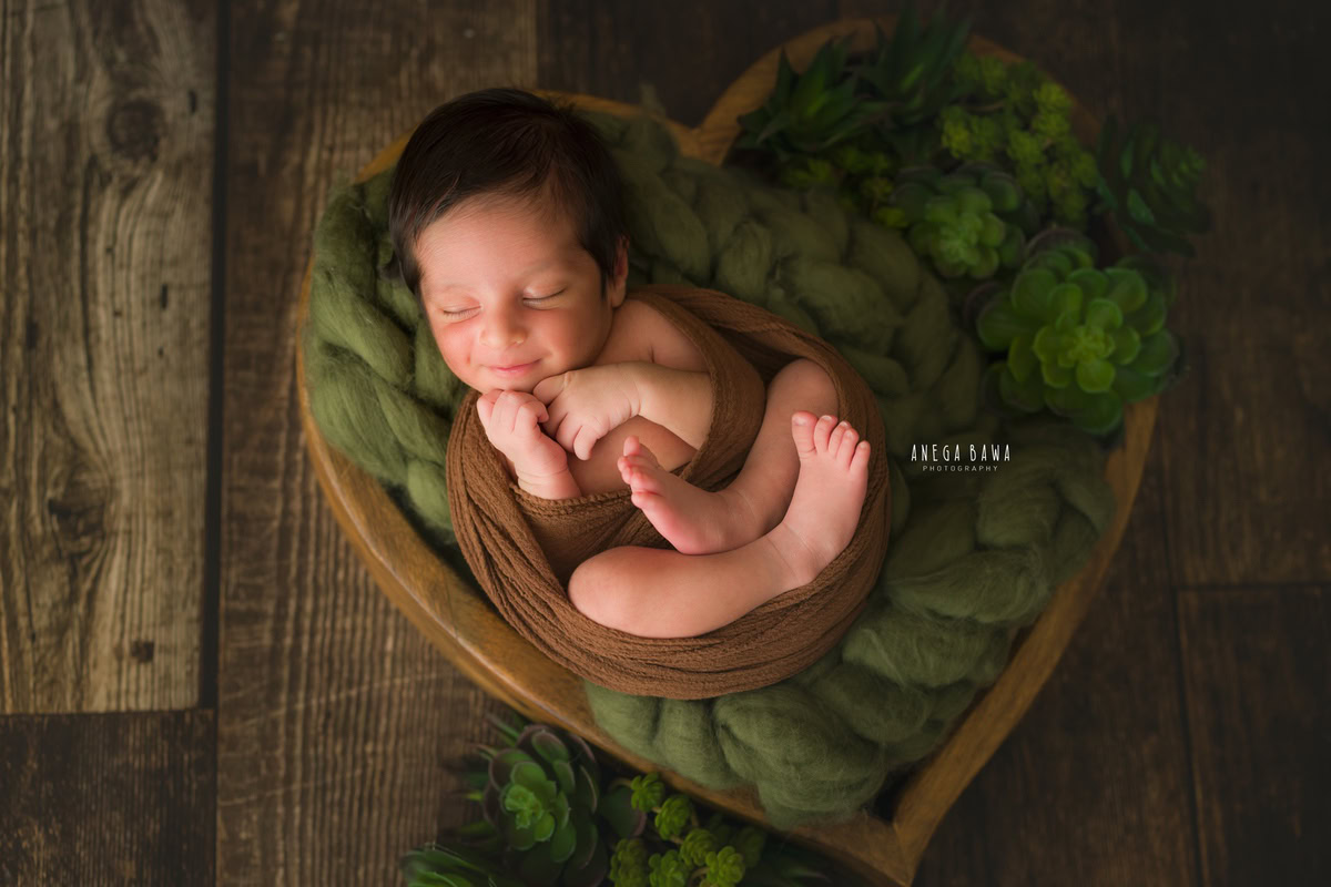 Newborn Photography in Delhi: Brown Wrap, Heart Basket, Brown Backdrop. Photographer: Anega Bawa Photoshoot, Gurgaon Noida.