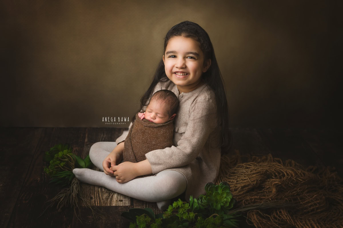 Newborn Photography in Delhi: Brown Wrap, Sibling, Brown Backdrop, by Anega Bawa Photographer, Gurgaon Noida.