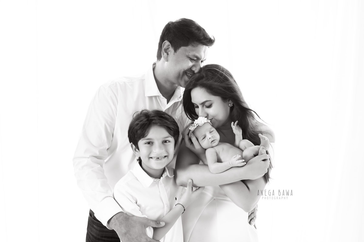 Newborn Photography in Delhi: A cute family portrait on a white backdrop. Photographer: Anega Bawa Photography, Gurgaon.