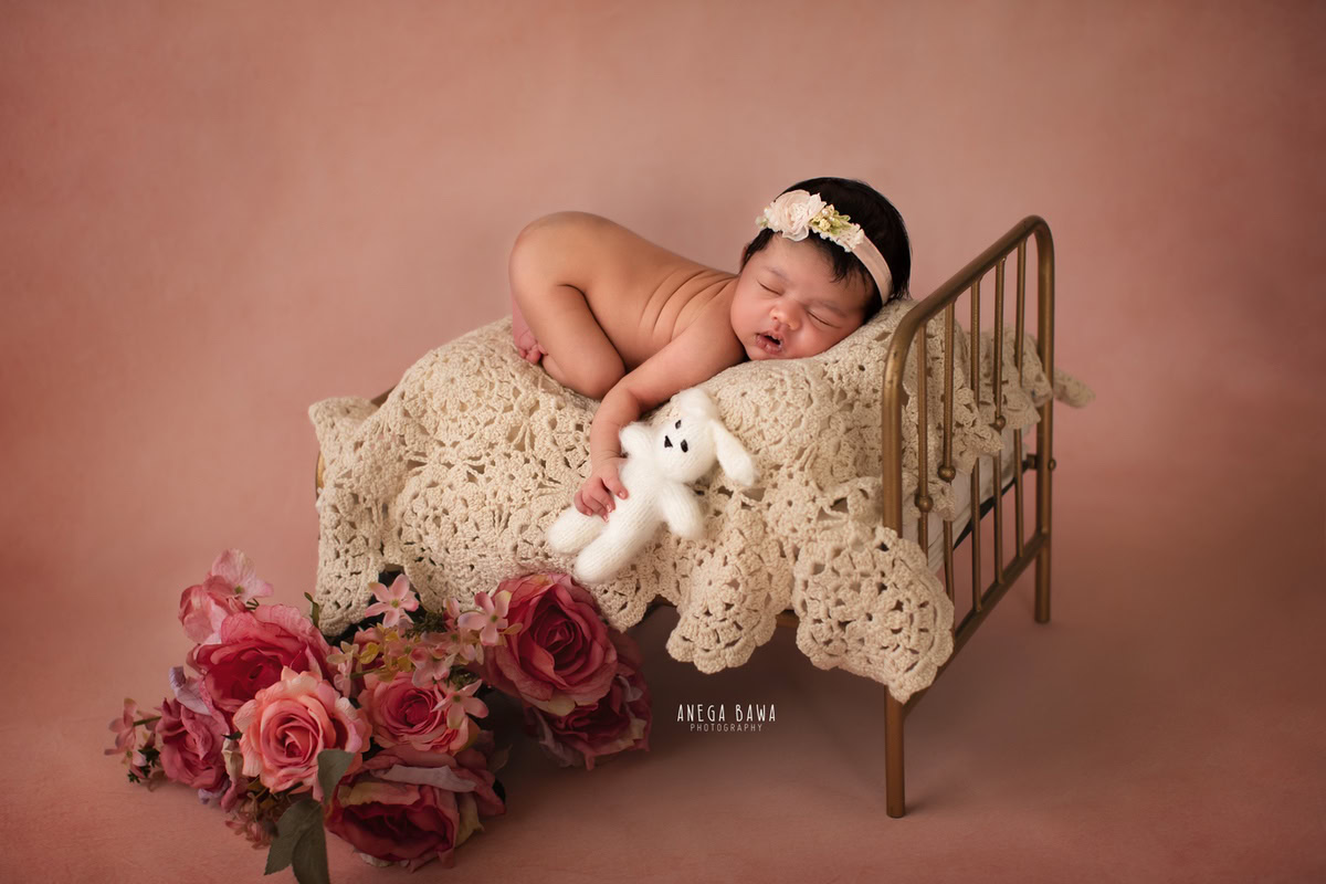Newborn Photography in Delhi: Cute Headband, Soft Toy, Peach Backdrop. Photographer: Anega Bawa Photoshoot, Gurgaon Noida.