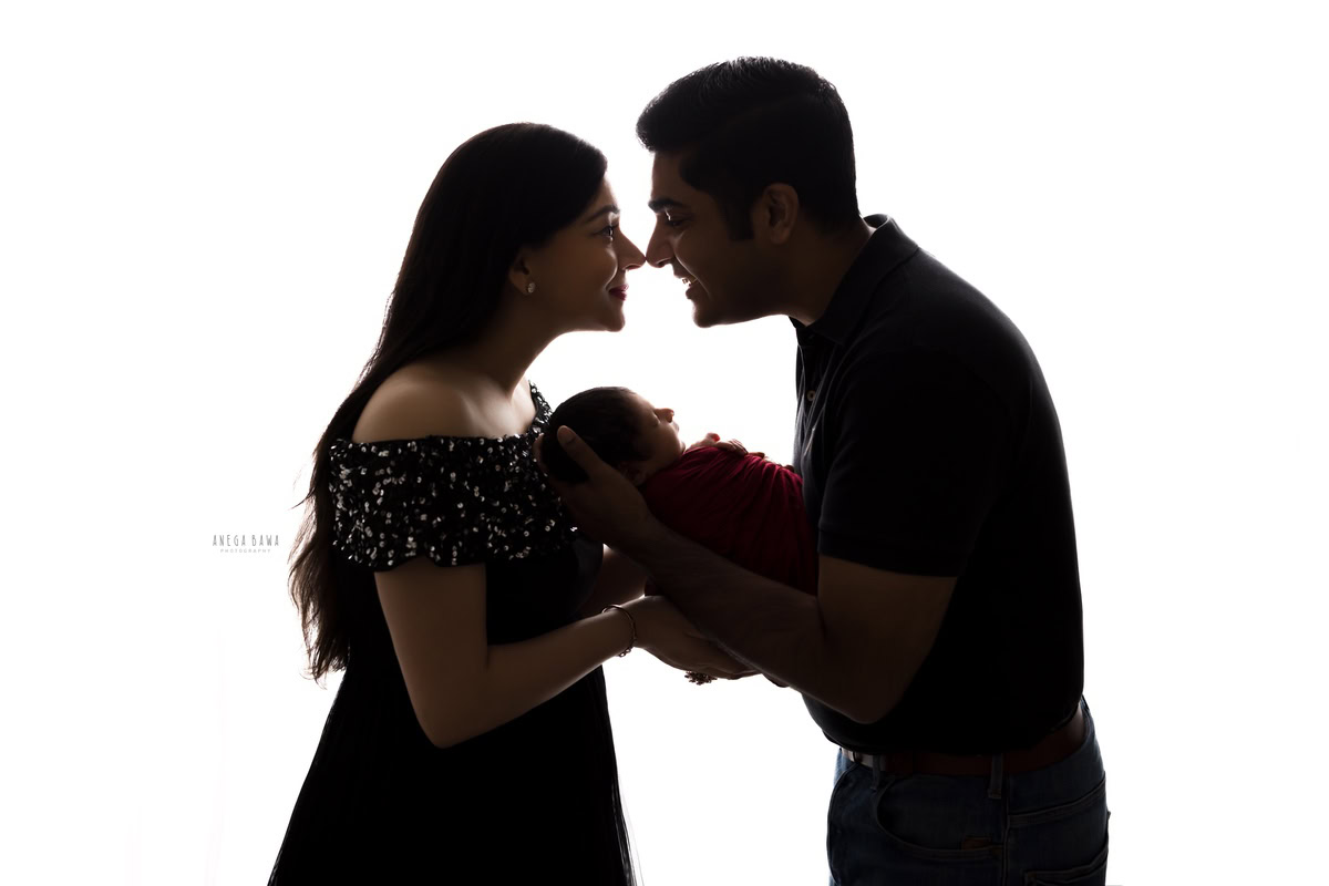 Newborn Photography in Delhi: Family portrait in black and white against a white backdrop, taken by Anega Bawa Photography in Gurgaon.