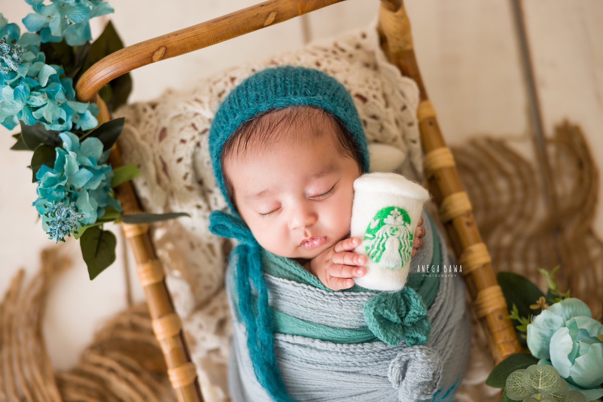 Newborn Photography in Delhi: Green and Blue Wrap with Wooden Basket and Cute Starbucks Glass. Photographer: Anega Bawa, Gurgaon Noida.
