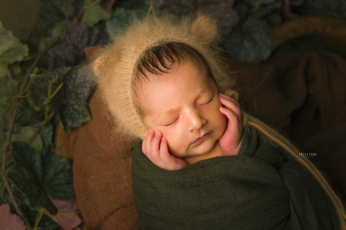 Newborn Photography in Delhi: Green Wrap, Brown Cap, Leafy Backdrop, by Anega Bawa Photographer, Gurgaon Noida.