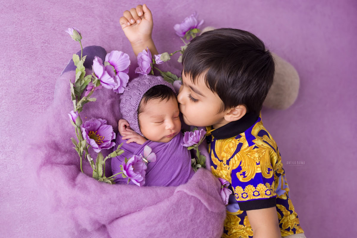 Newborn Photography in Delhi: Lavender Wrap, Sibling Kiss Pose, Lavender Backdrop, by Anega Bawa Photographer, Gurgaon Noida.