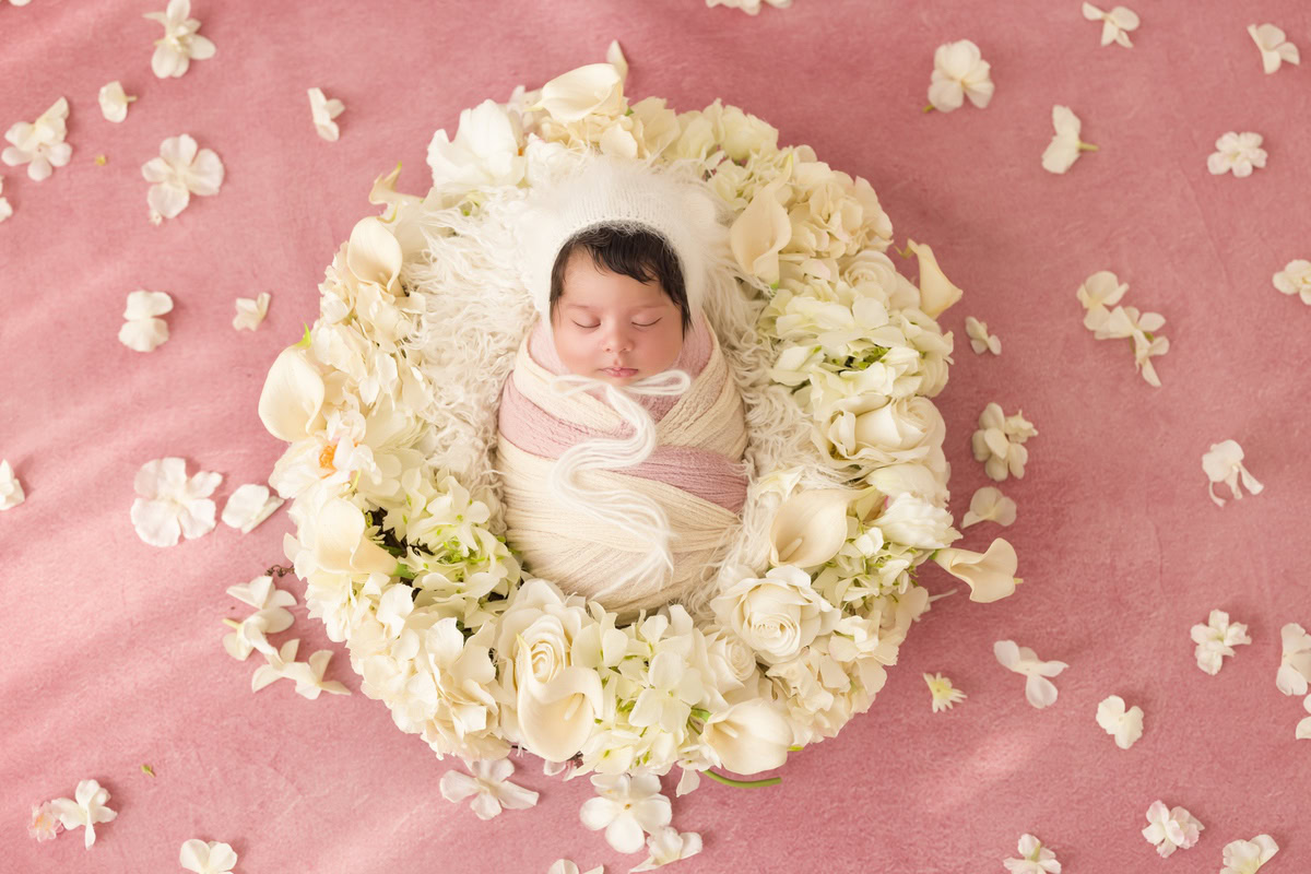 Newborn Photography in Delhi: Pink Rug, White Flowers on Floor, Flower Basket, by Anega Bawa Photographer, Gurgaon Noida.