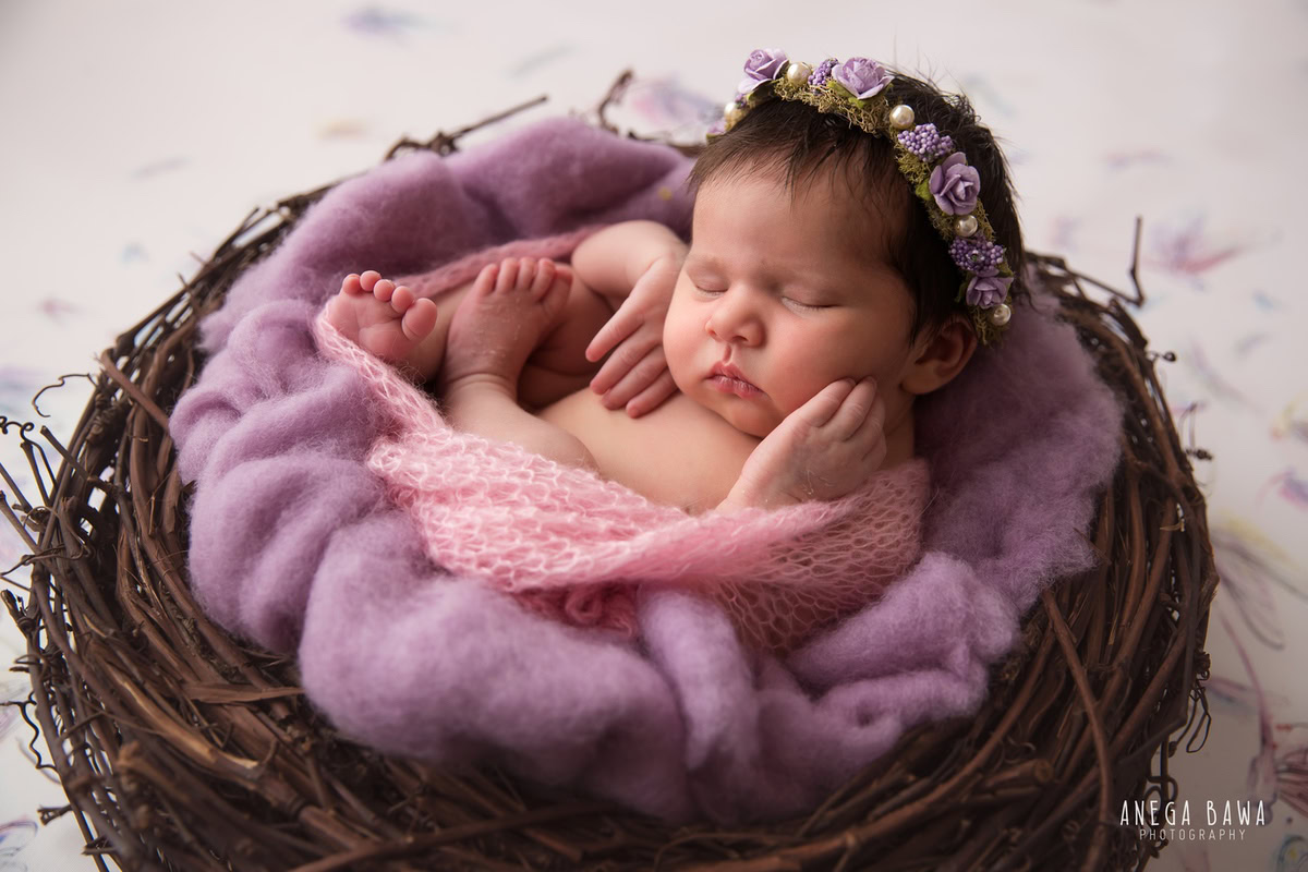 Newborn Photography in Delhi: Pink Wrap, Wooden Basket, Lavender Blanket, White Backdrop. Photographer: Anega Bawa, Gurgaon Noida.