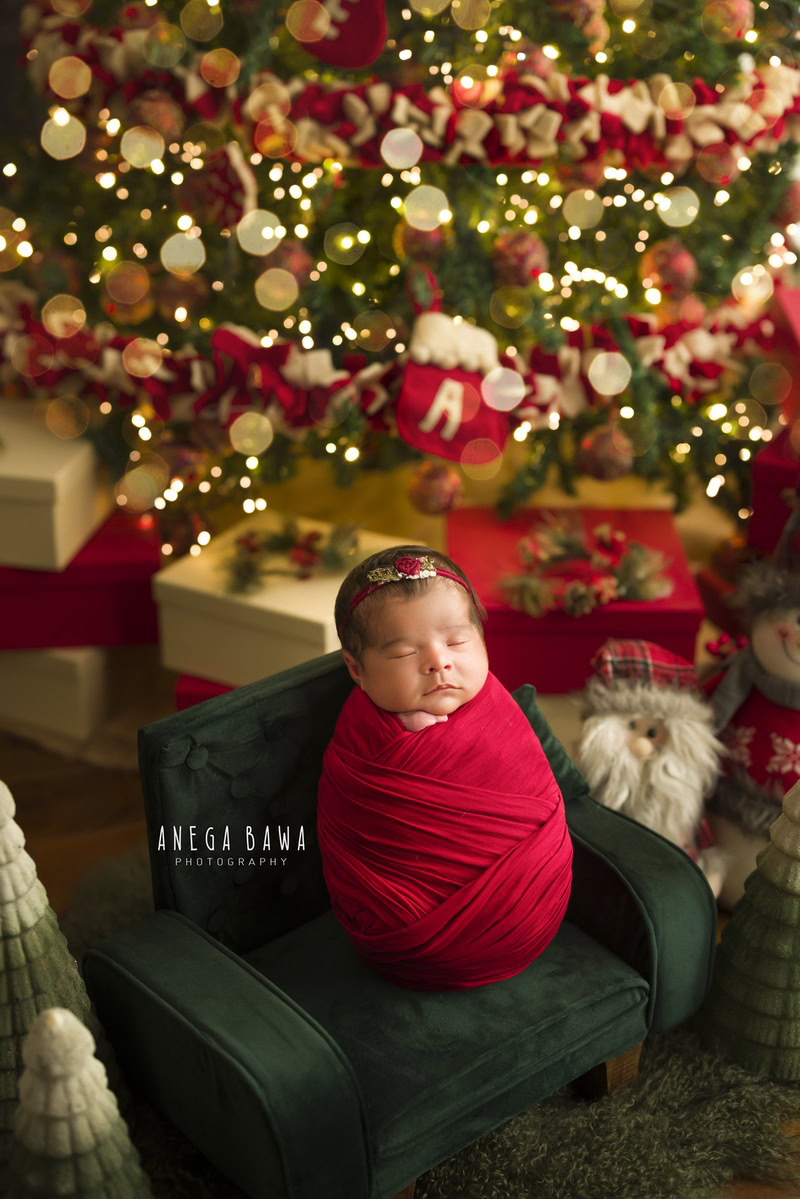 Newborn Photography in Delhi: Red Wrap, Green Chair, Christmas Lights, by Anega Bawa Photographer, Gurgaon Noida.