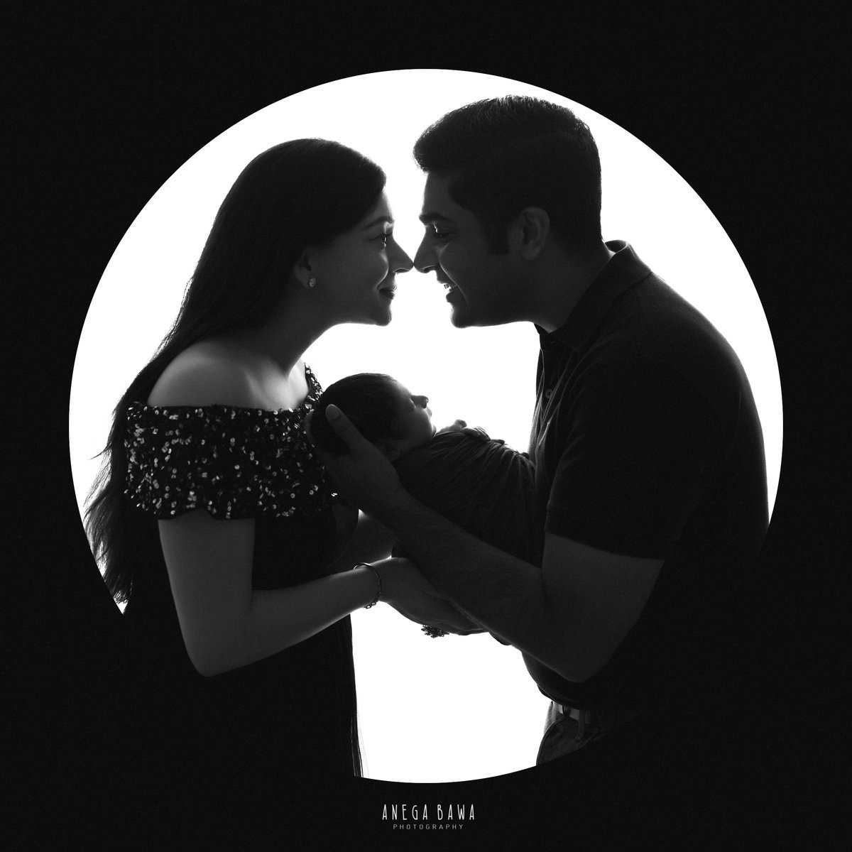 Newborn Photography in Gurgaon: Parents touching newborn's nose. Photographer: Anega Bawa, Delhi.