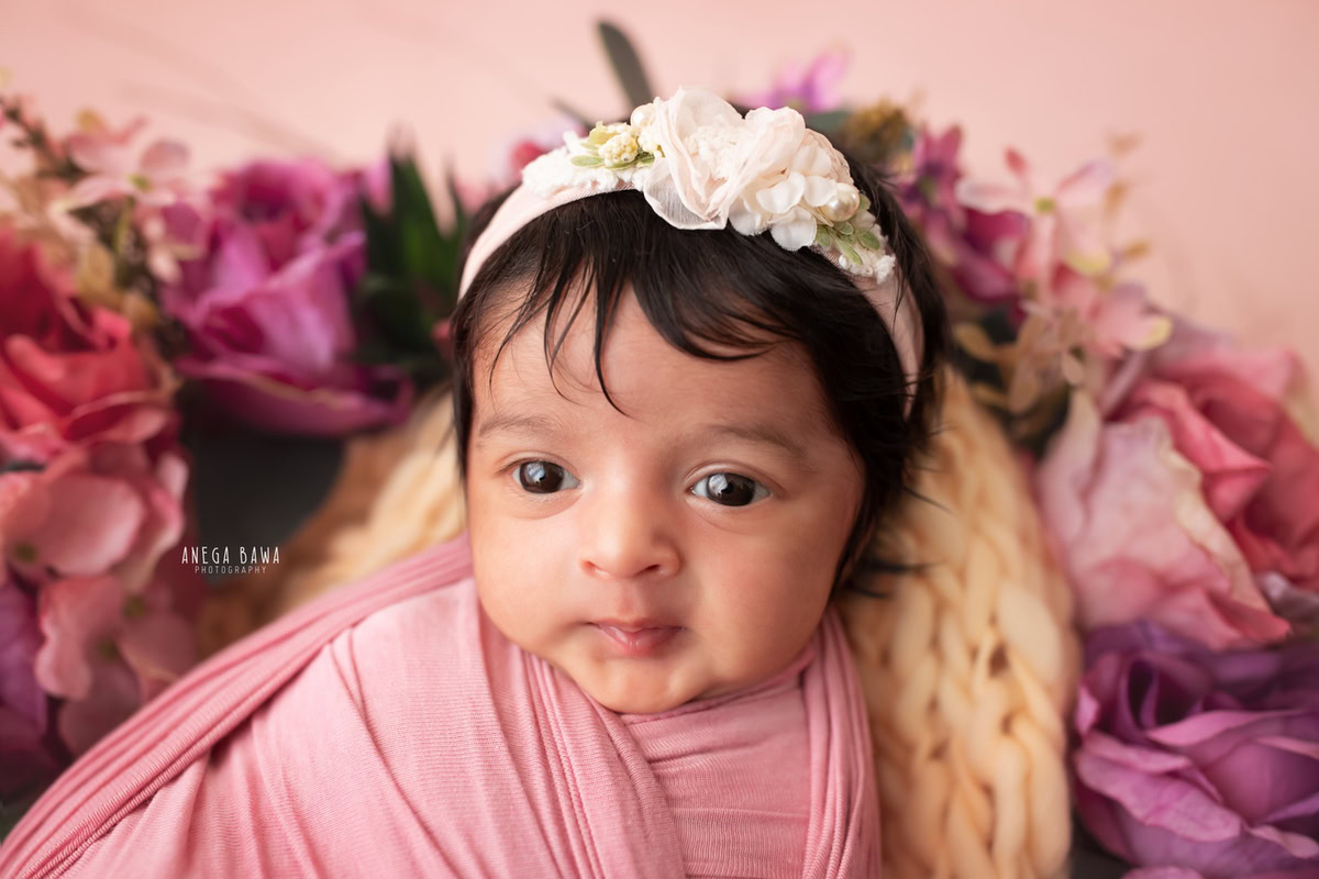 Newborn Photography at Home in Delhi: Pink Wrap, Pink Backdrop, Beautiful Eyes. Photographer: Anega Bawa, Gurgaon Noida.