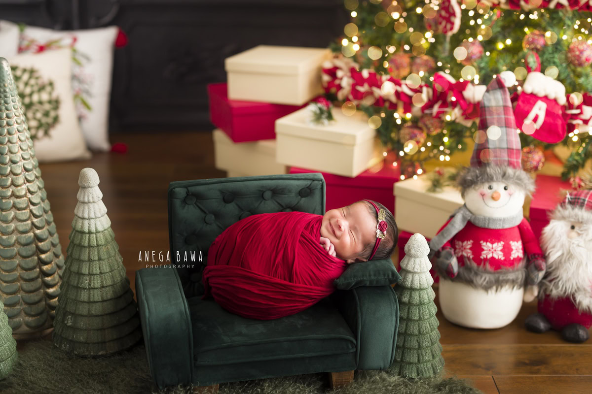 Newborn Photography at Home in Delhi: Red Wrap, Green Chair, Christmas Theme. Photographer: Anega Bawa, Gurgaon Noida.