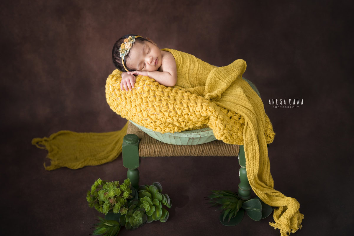 Newborn Photography at Home in Delhi: Yellow Wrap with Brown Backdrop. Photographer: Anega Bawa, Gurgaon Noida.