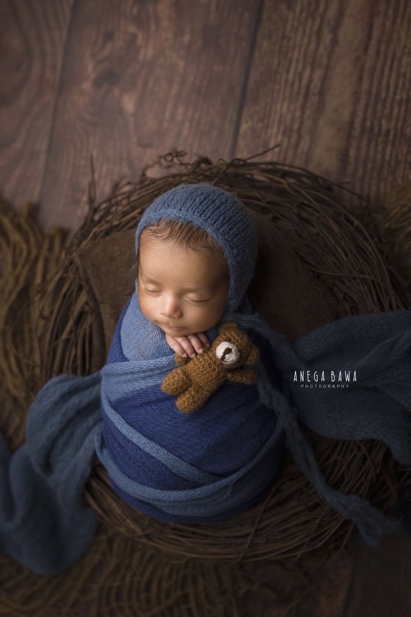 Newborn Photoshoot in Delhi: Blue Wrap with Brown Backdrop and Soft Toy. Photographer: Anega Bawa Photography, Gurgaon Noida.