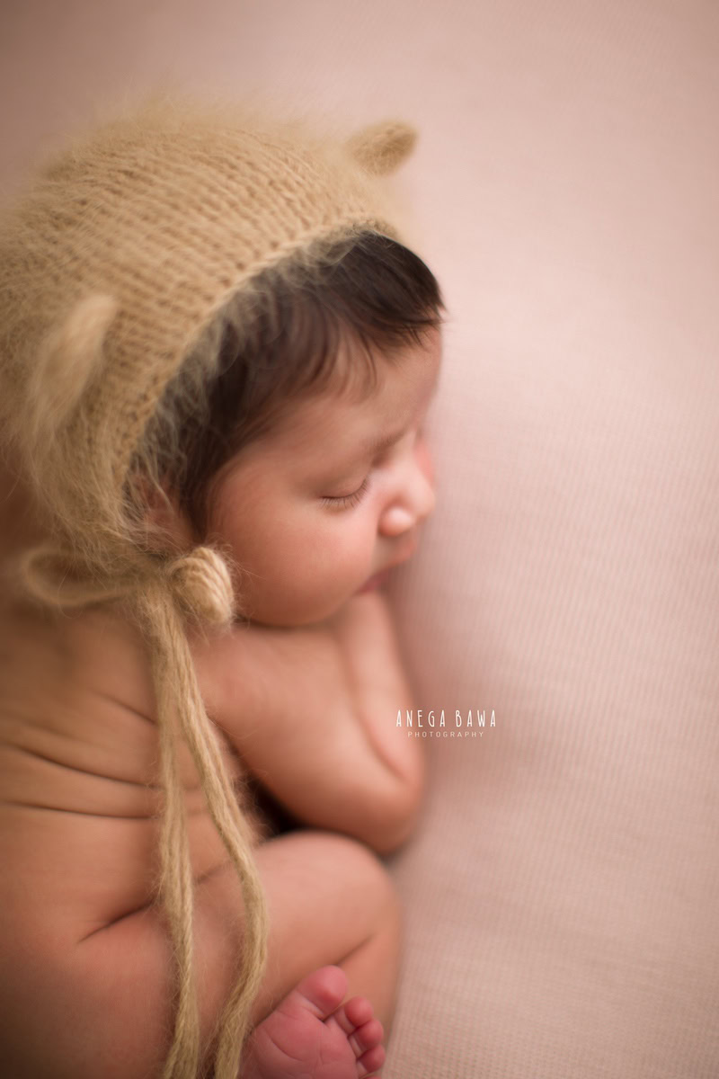 Newborn Photoshoot in Delhi: Brown Cap, Sleeping Pose. Photographer: Anega Bawa Photography, Gurgaon Noida.