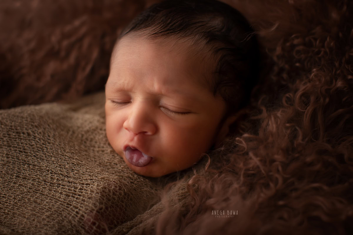 Newborn Photoshoot in Delhi: Brown Wrap, Capturing a Cute Pout Pose. Photographer: Anega Bawa Photography, Gurgaon Noida.