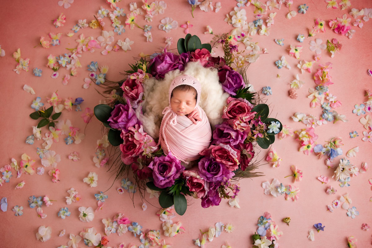 Newborn Photoshoot in Delhi: Pink Wrap, Floral Basket, Petals on Floor. Photographer: Anega Bawa Photography, Gurgaon Noida.