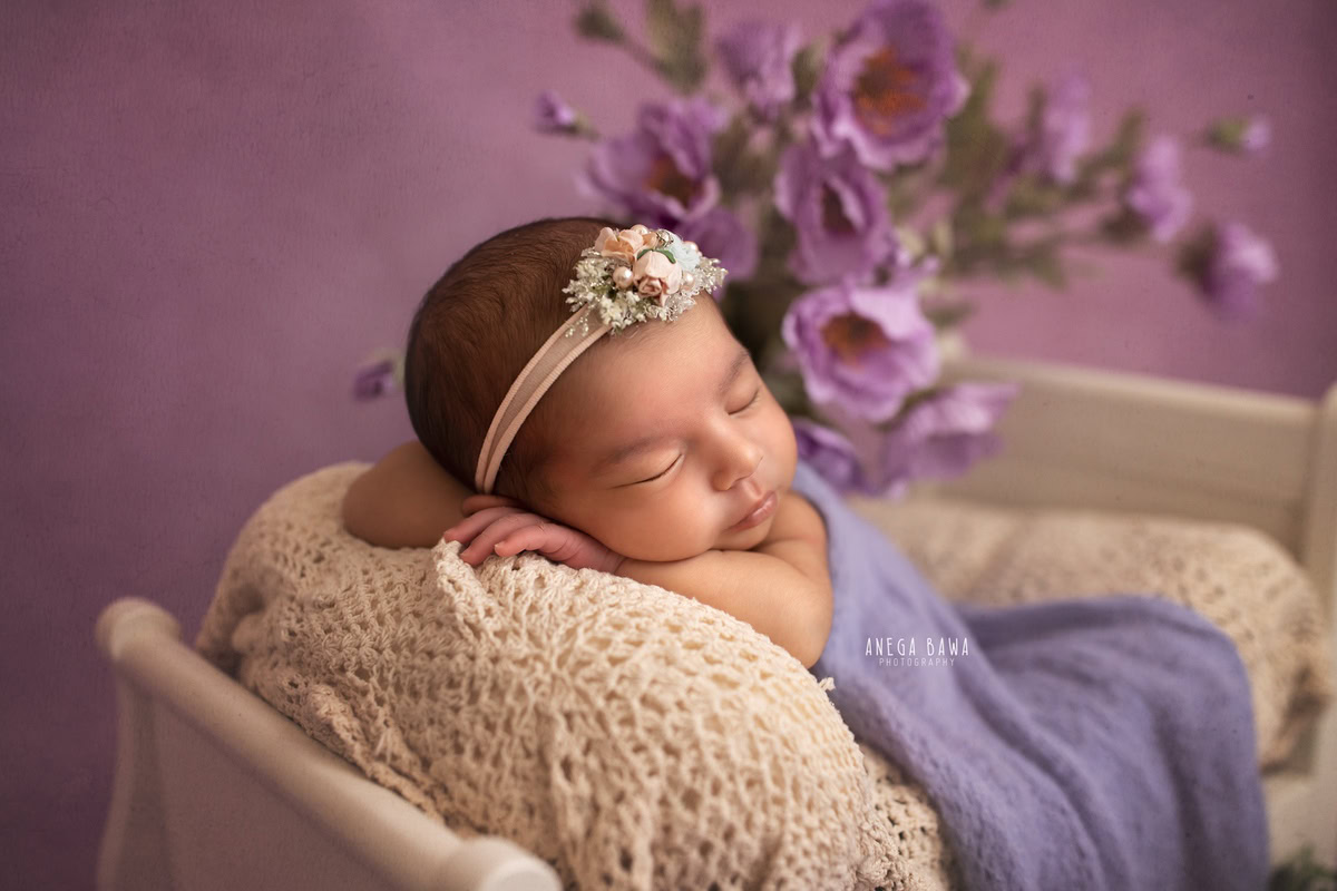 Newborn Photoshoot in Delhi: Purple Wrap with Lavender Backdrop. Photographer: Anega Bawa Photography, Gurgaon Noida.