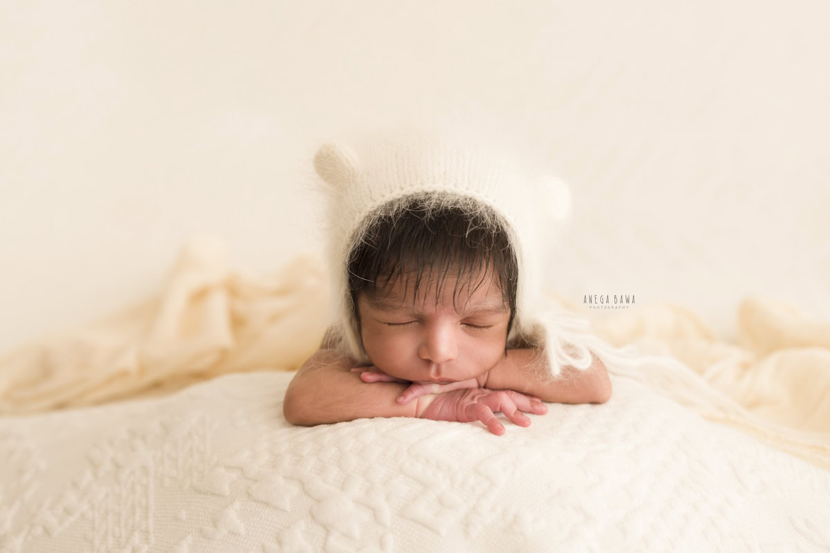 Newborn Photoshoot in Delhi: White Cap, Sleeping Pose. Photographer: Anega Bawa, Gurgaon Noida.