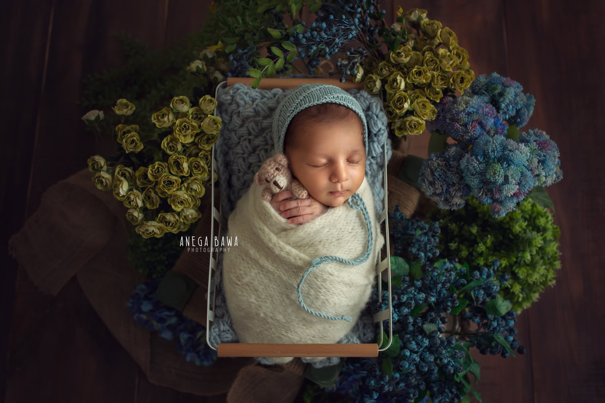 Newborn Photoshoot in Delhi: White Wrap with Blue-Green Backdrop. Photographer: Anega Bawa Photography, Gurgaon Noida.