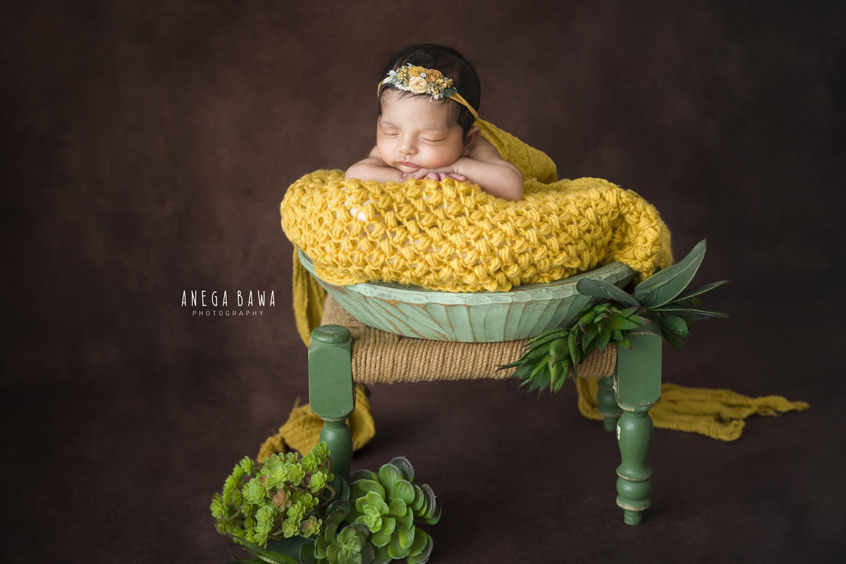 Newborn Photoshoot in Delhi: Yellow Blanket with Yellow Headband. Photographer: Anega Bawa, Gurgaon Noida.