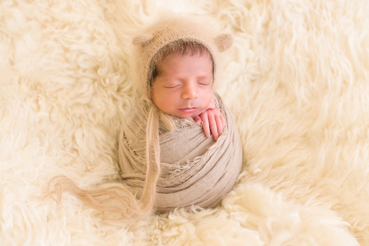 Newborn Photoshoot in Gurgaon: Brown Wrap, Beige Rug, Beige Backdrop. Photographer: Anega Bawa, Delhi Noida.