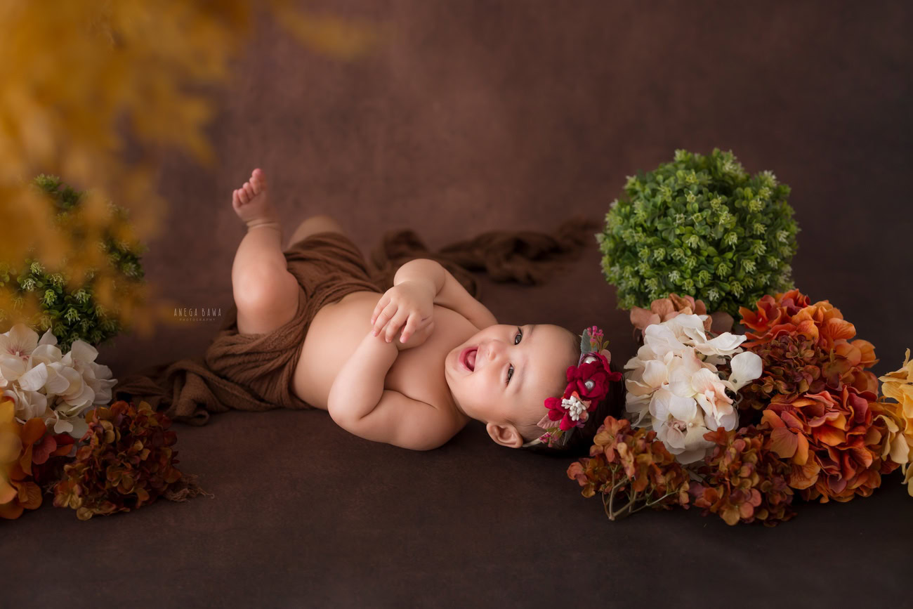 Baby boy photo shoot, 6 or 5 or 3 or 4 months, brown backdrop, brown wrap, cute smiling pose. Location: Delhi, Gurgaon, Noida. Photographer: Anega Bawa.