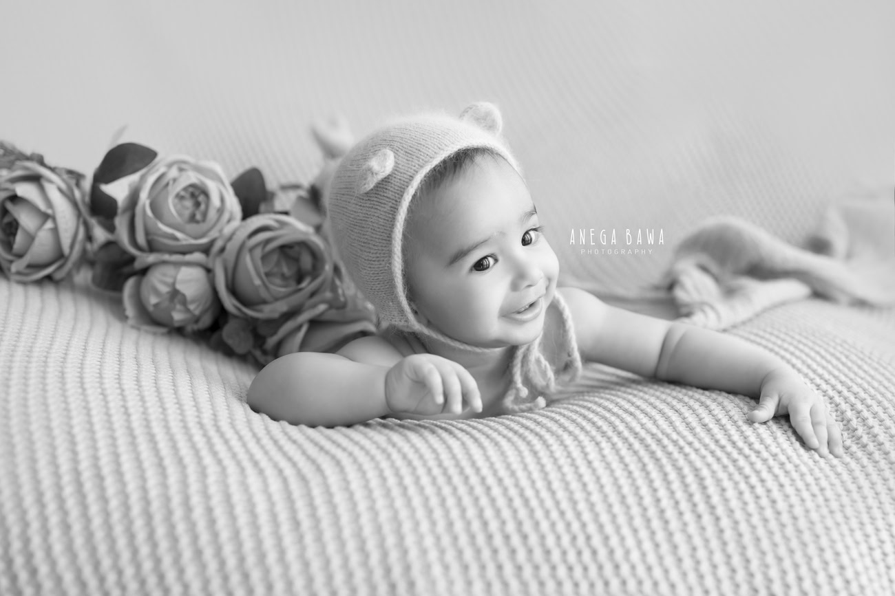 Capture the adorable essence of your 3, 4, 5, or 6-month-old baby boy in a cute cap, radiating charm in black and white hues. Contact Anega Bawa for your baby boy's photoshoot in Delhi, Gurgaon, or Noida.