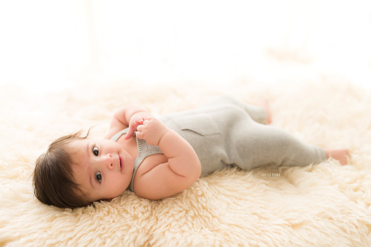 Baby boy photo shoot, 6 or 5 or 3 or 4 months, grey baby boy suit, beige backdrop. Location: Delhi, Gurgaon, Noida. Photographer: Anega Bawa.