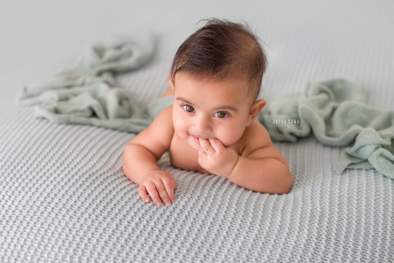 Baby boy photo shoot, 6 or 5 or 3 or 4 months, grey backdrop, grey sheet, cute pose. Location: Delhi, Gurgaon, Noida. Photographer: Anega Bawa.