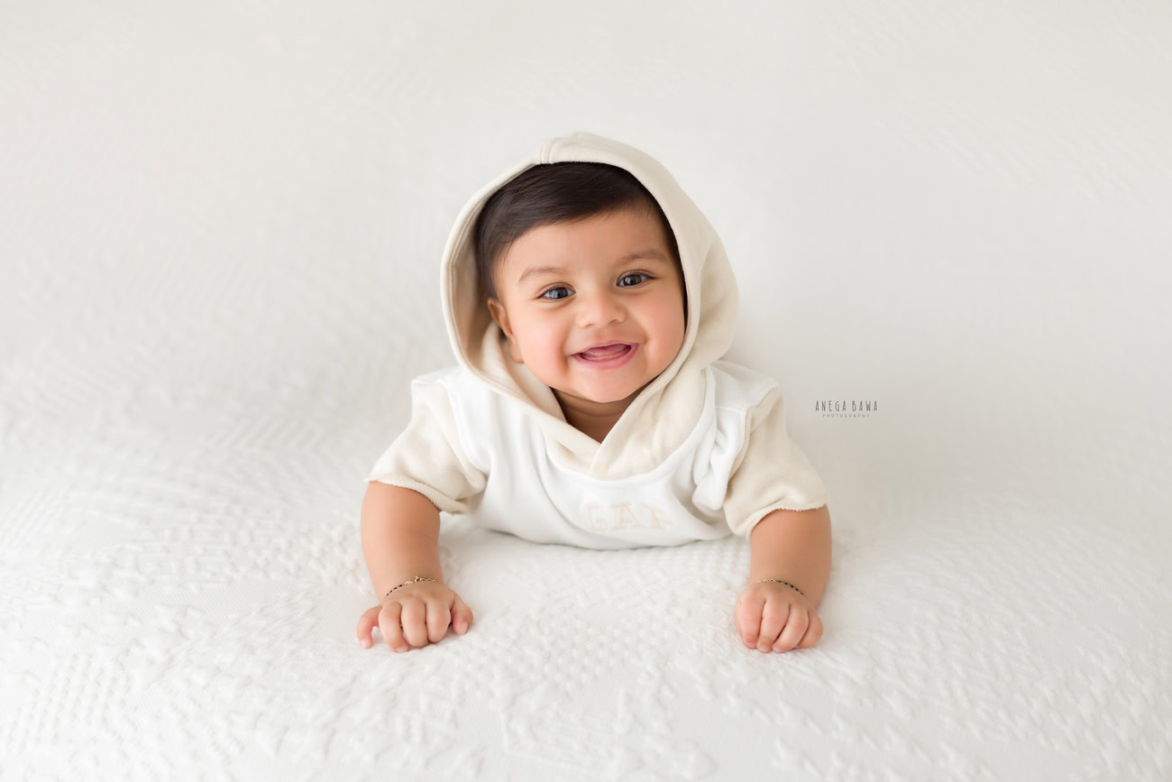 Baby boy photo shoot, 6 or 5 or 3 or 4 months, white baby boy suit, white backdrop. Location: Delhi, Gurgaon, Noida. Photographer: Anega Bawa.